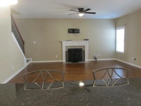 wooden floor in an empty room with a fireplace