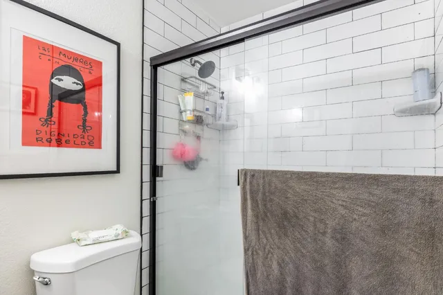 a bathroom with a shower and a toilet