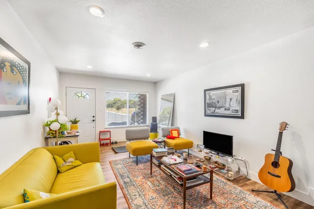 a living room with furniture a rug and a fireplace
