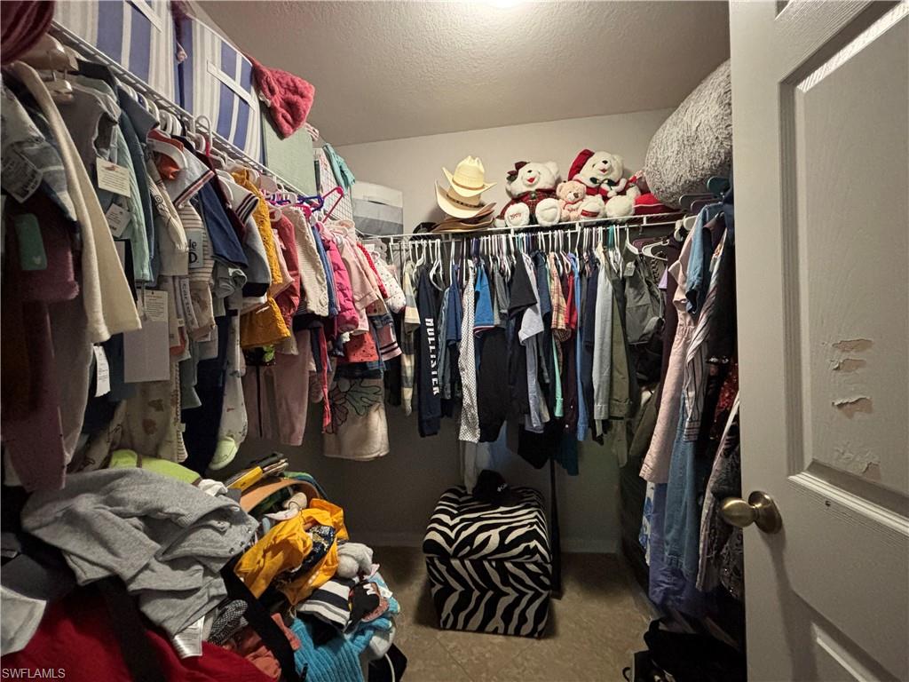 1243 Madison Court Immokalee, FL 34142 - Photo 15 of 32 a view of walk in closet with clothes