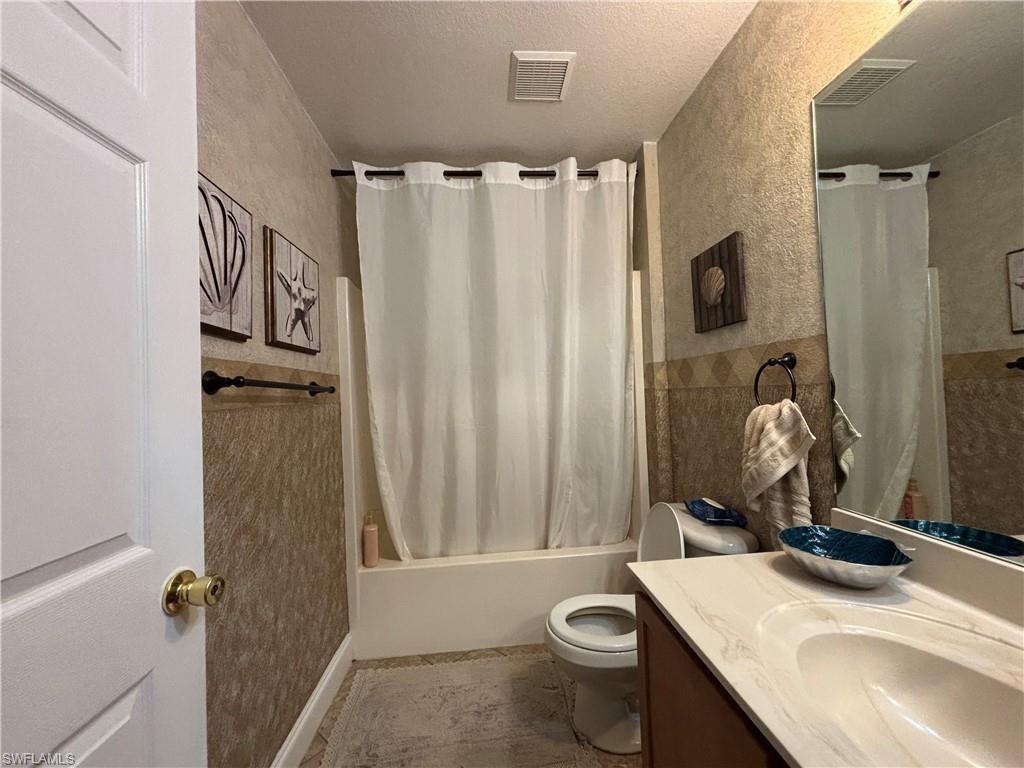 1243 Madison Court Immokalee, FL 34142 - Photo 19 of 32 a bathroom with a sink toilet and shower
