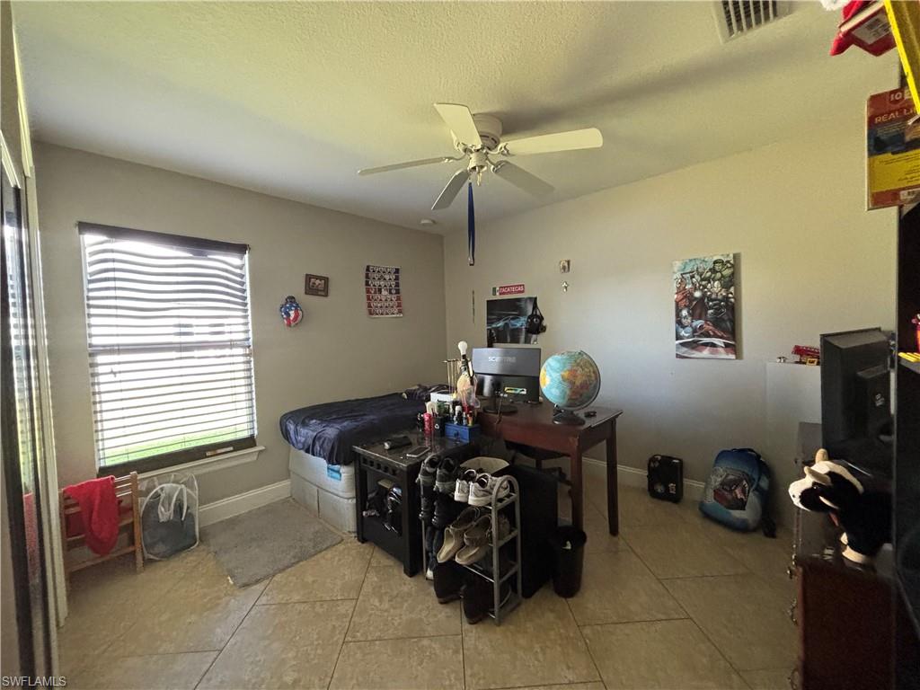 1243 Madison Court Immokalee, FL 34142 - Photo 21 of 32 a living room with furniture and a window