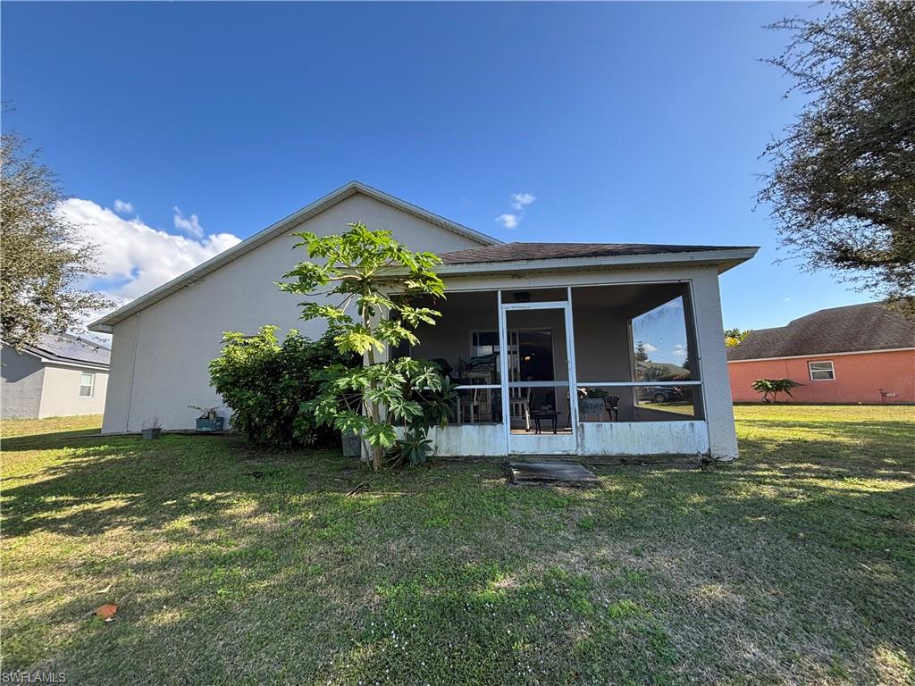 1243 Madison Court Immokalee, FL 34142 - Photo 25 of 32 a view of a house with a yard