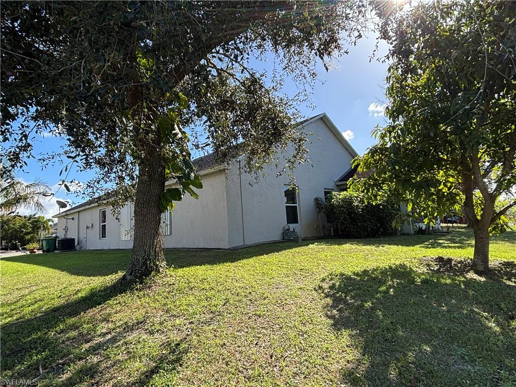 1243 Madison Court Immokalee, FL 34142 - Photo 27 of 32 a backyard of a house with lots of green space