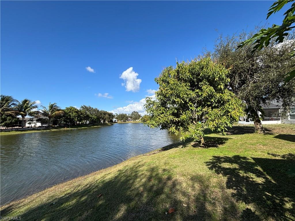 1243 Madison Court Immokalee, FL 34142 - Photo 31 of 32 a view of a lake with houses
