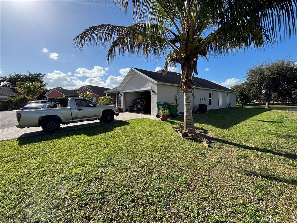 1243 Madison Court Immokalee, FL 34142 - Photo 4 of 32 a front view of a house with garden