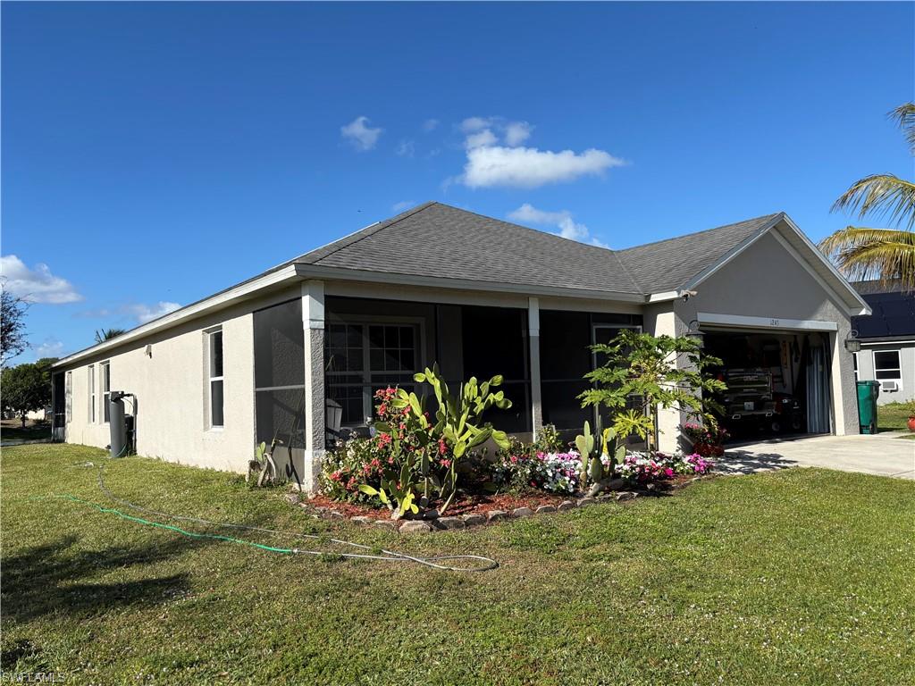 1243 Madison Court Immokalee, FL 34142 - Photo 5 of 32 a front view of a house with a yard