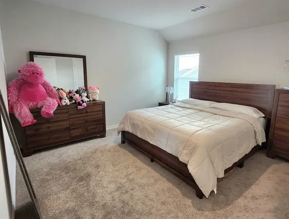 a bedroom with a bed and a mirror