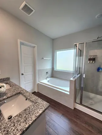 a white toilet sitting next to a bath tub