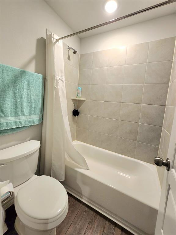 9824 Dynamic Drive Fort Worth, TX 76131 - Photo 14 of 17 a white toilet sitting next to a bath tub