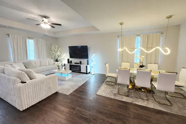 a living room with furniture a dining table and a fireplace