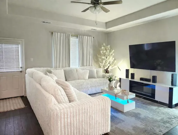 a kitchen with stainless steel appliances granite countertop a sink a stove and a refrigerator with wooden floor
