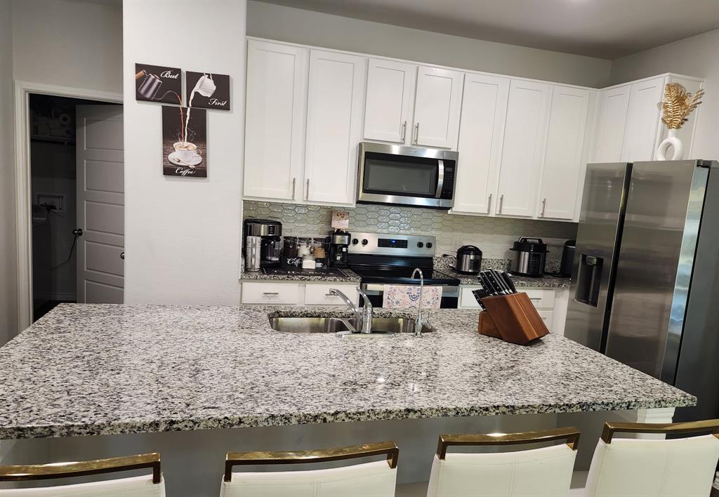 9824 Dynamic Drive Fort Worth, TX 76131 - Photo 8 of 17 a kitchen with stainless steel appliances granite countertop a sink a stove and refrigerator