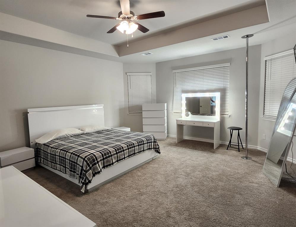 9824 Dynamic Drive Fort Worth, TX 76131 - Photo 10 of 17 a bedroom with a bed and a chandelier