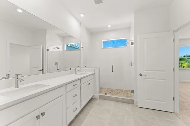 a spacious bathroom with 2 sink tub and a mirror