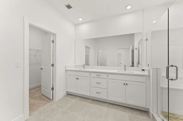a bathroom with a double vanity sink mirror and double