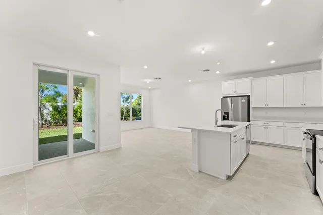 a view of kitchen with furniture and refrigerator