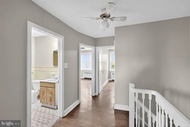 a view of hallway with wooden floor