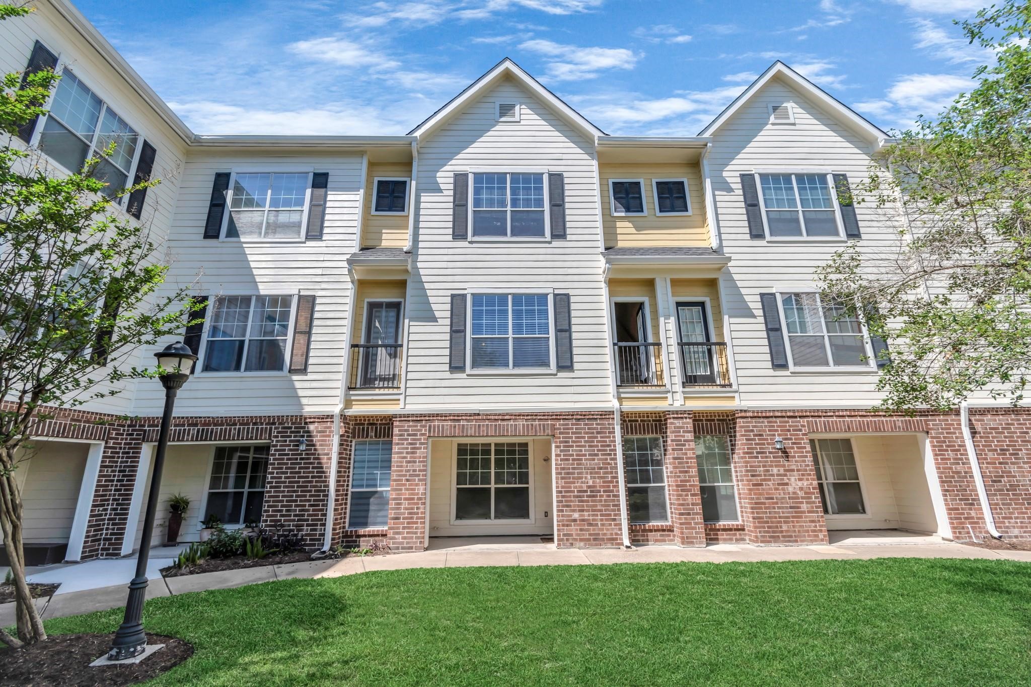 9200 Westheimer Road, Unit 1607 Houston, TX 77063 - Photo 1 of 34 a front view of a house with a yard and green space