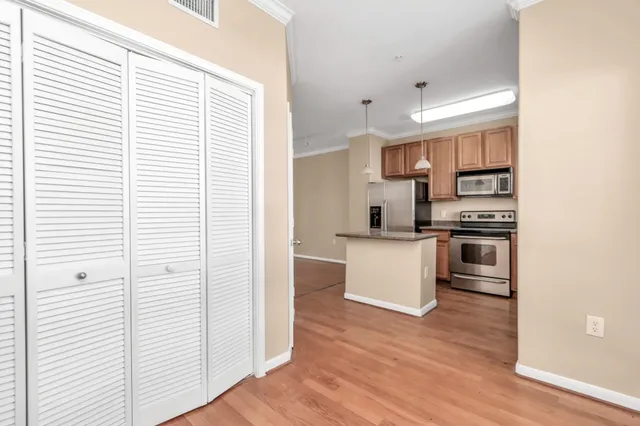 a kitchen with stainless steel appliances a refrigerator and a stove top oven