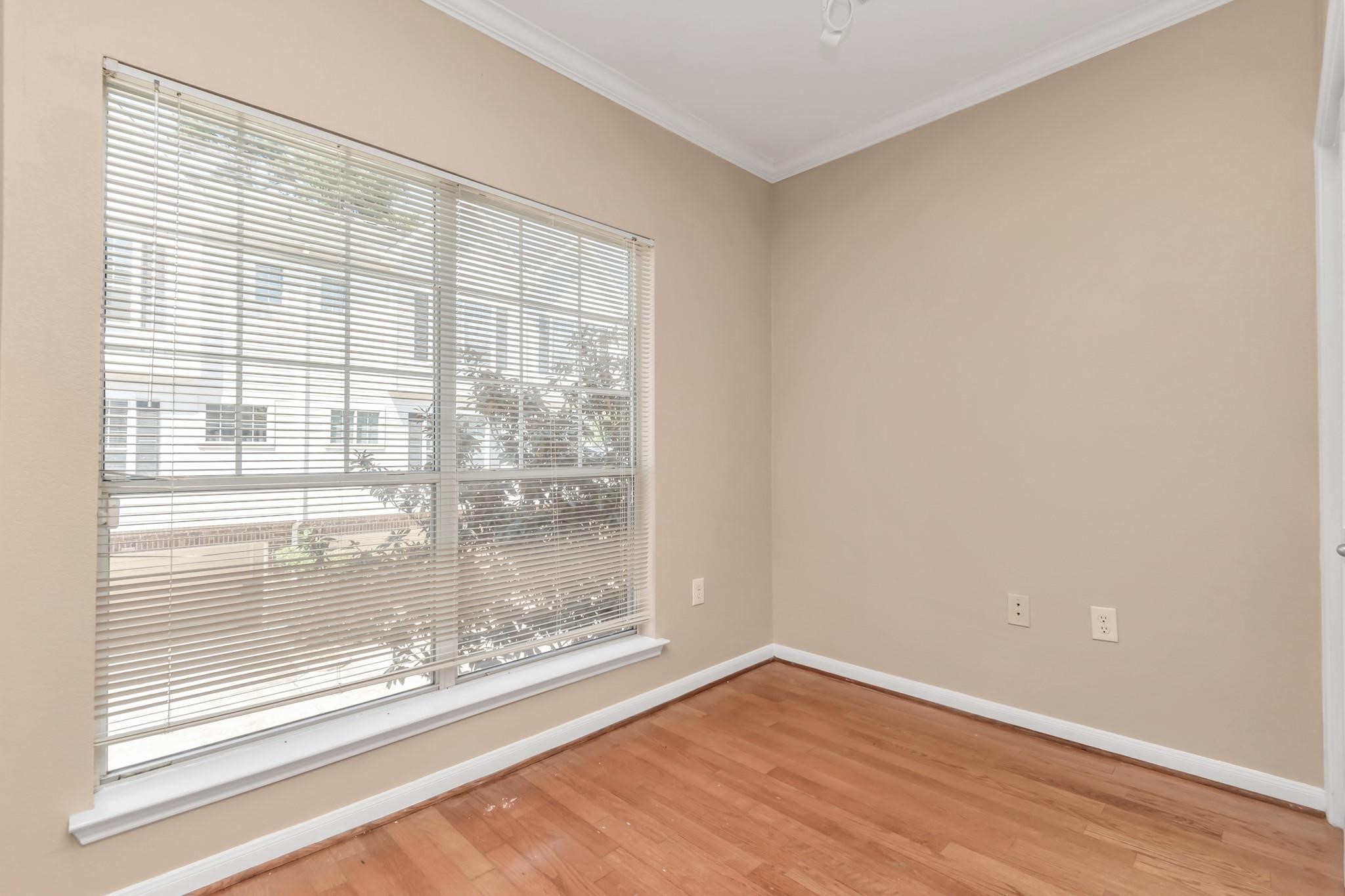 9200 Westheimer Road, Unit 1607 Houston, TX 77063 - Photo 15 of 34 a view of a room with wooden floor and doors
