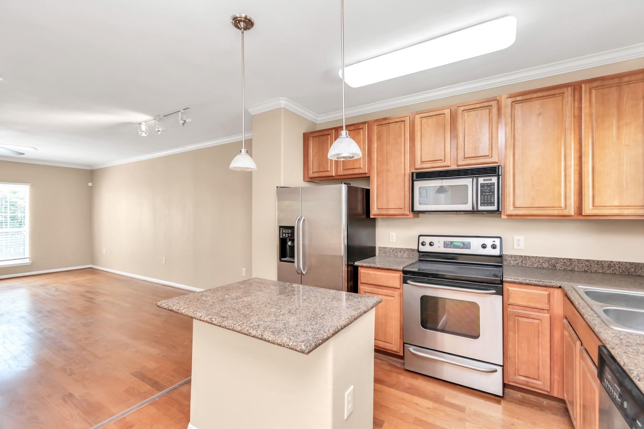 9200 Westheimer Road, Unit 1607 Houston, TX 77063 - Photo 6 of 34 a kitchen with stainless steel appliances granite countertop a stove a refrigerator and a sink