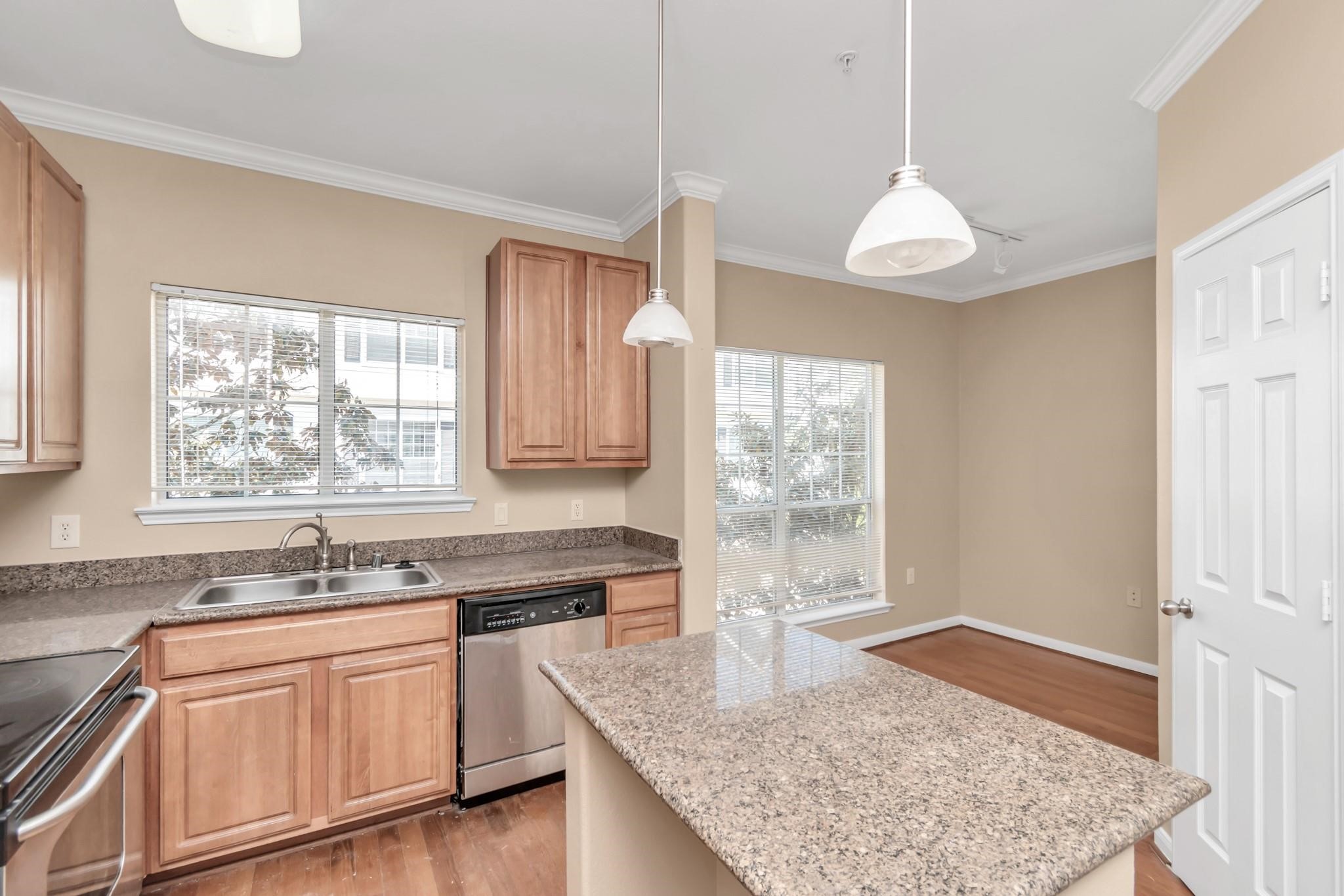 9200 Westheimer Road, Unit 1607 Houston, TX 77063 - Photo 10 of 34 a kitchen with stainless steel appliances granite countertop a sink window and cabinets