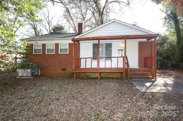 a house that has a small yard and a large tree