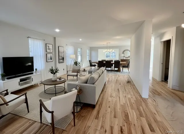 a living room with furniture fireplace and flat screen tv