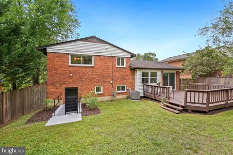 a view of a house with a yard and deck
