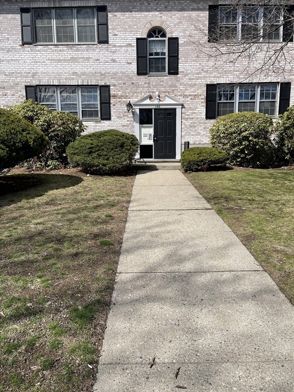 166 Lake Shore Road, Unit 1 Boston, MA 02135 - Photo 9 of 9 a front view of a house with a yard