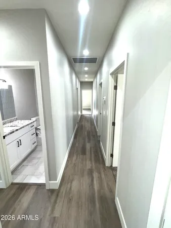 a view of a hallway with wooden floor