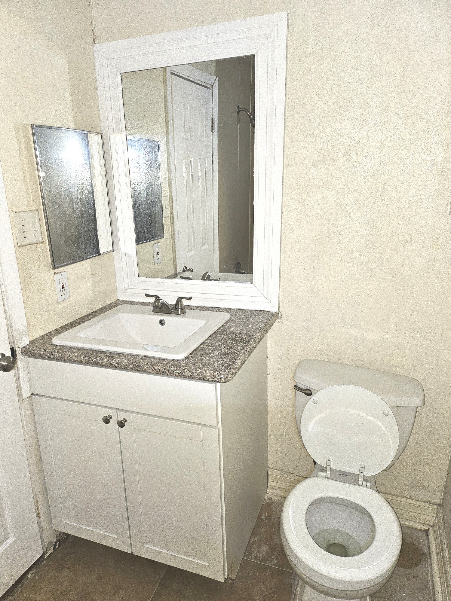 15829 Ridgeroe Lane Houston, TX 77053 - Photo 10 of 15 a bathroom with a toilet a sink and mirror