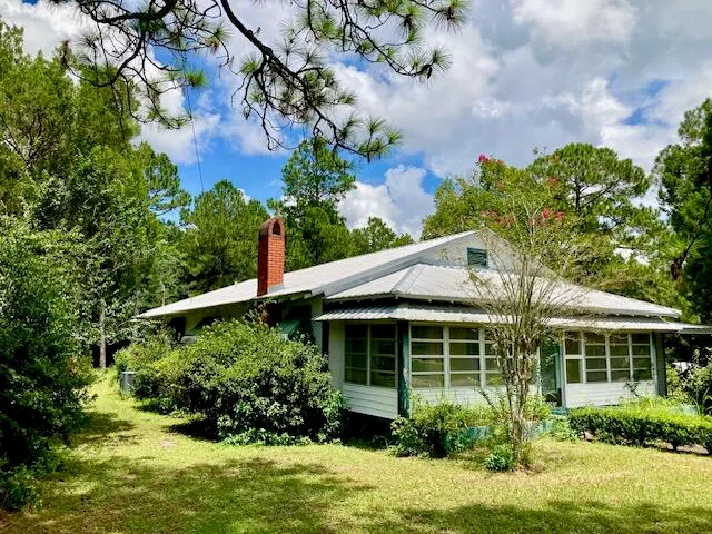 a view of a house with garden and plants