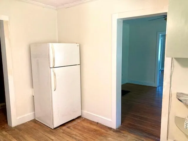 a view of walk in closet with wooden floor