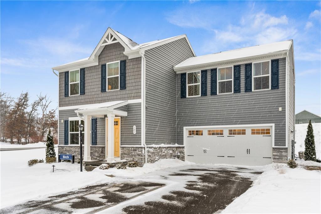 a front view of a house with a road