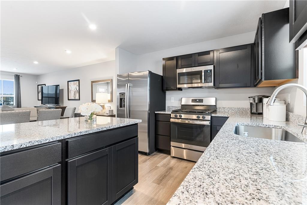 101 Jerome Drive Butler, PA 16001 - Photo 7 of 34 a kitchen with stainless steel appliances granite countertop a sink stove and refrigerator