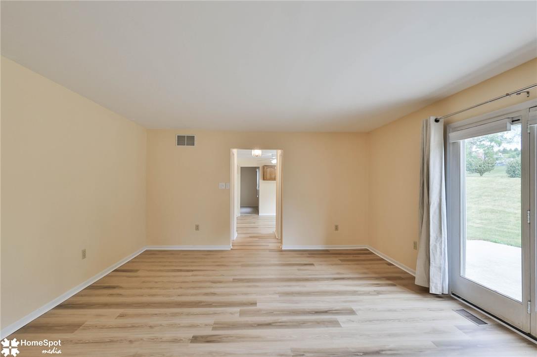 4059 Wedgewood Road Allentown, PA 18104 - Photo 27 of 72 Hardwood-style flooring extends through this airy living space with sliding glass doors leading to the outdoors.