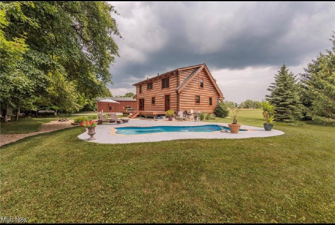 9485 Stone Road Litchfield, OH 44253 - Photo 3 of 50 View of pool with a lawn and a patio area