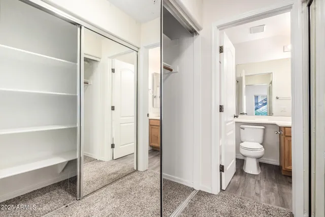 a bathroom with a granite countertop toilet and a shower