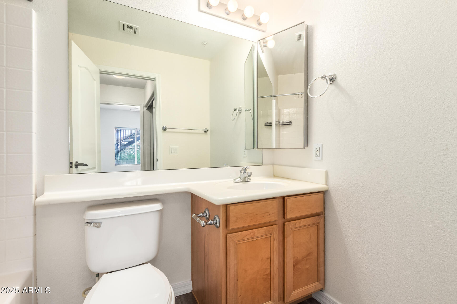 2201 North Comanche Drive, Unit 1104 Chandler, AZ 85224 - Photo 15 of 25 a bathroom with a toilet sink and mirror