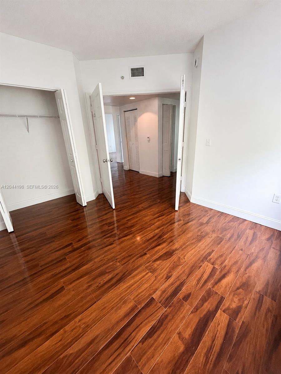 17145 North Bay Road, Unit 4307 Sunny Isles Beach, FL 33160 - Photo 19 of 35 a view of empty room with wooden floor