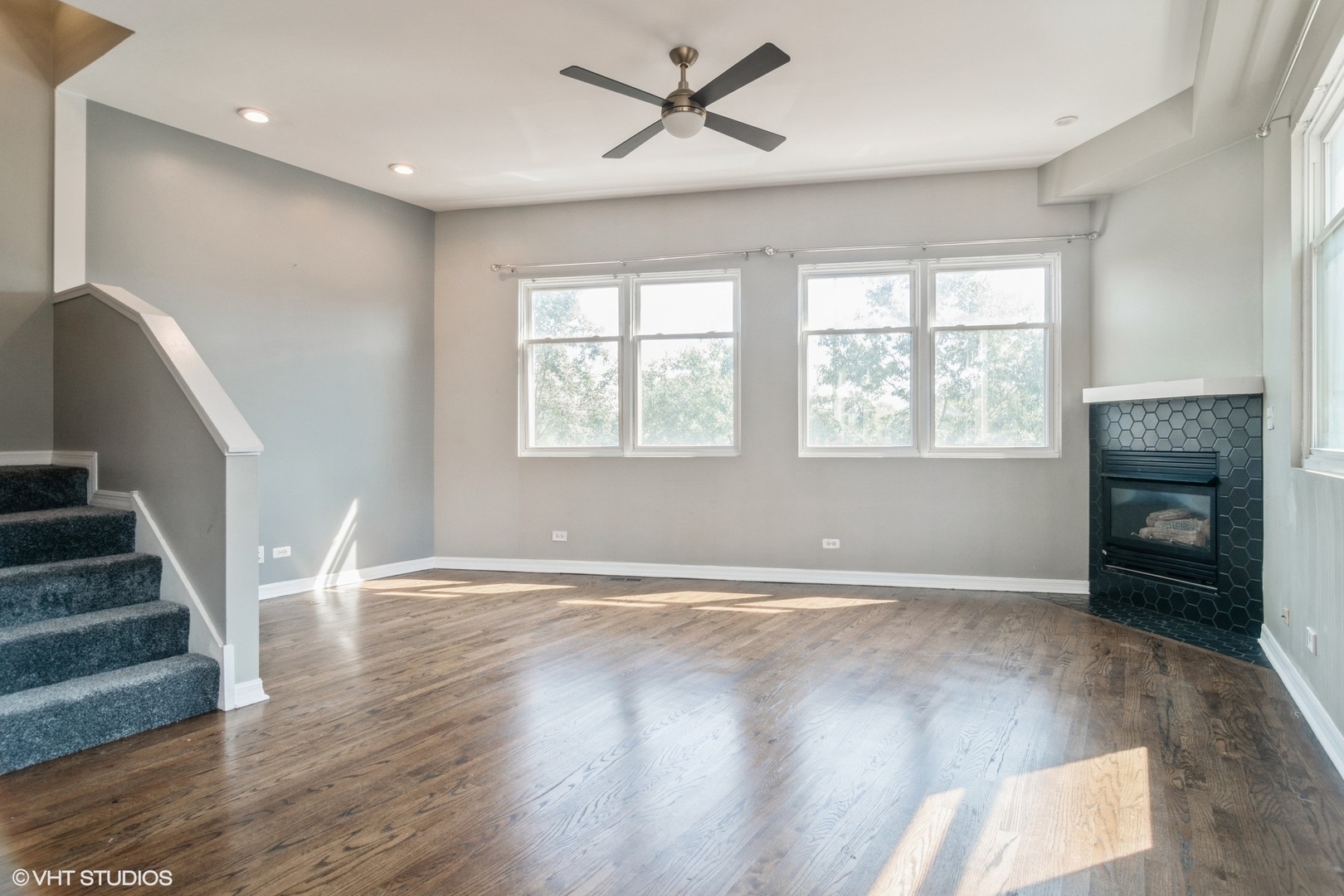 Undisclosed Address Chicago, IL 60642 - Photo 2 of 17 a view of an empty room with wooden floor fireplace and a window