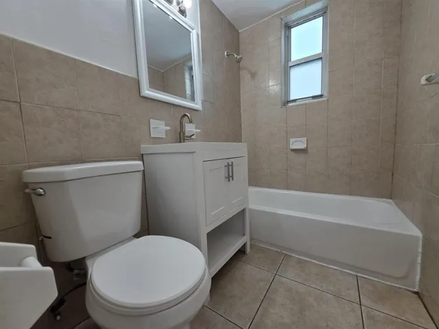 a bathroom with a toilet a sink and bathtub