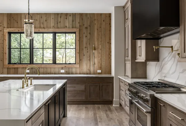 a kitchen with stainless steel appliances a sink a stove and cabinets