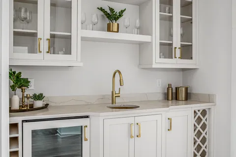 a bathroom with a granite countertop sink a mirror and a bathtub