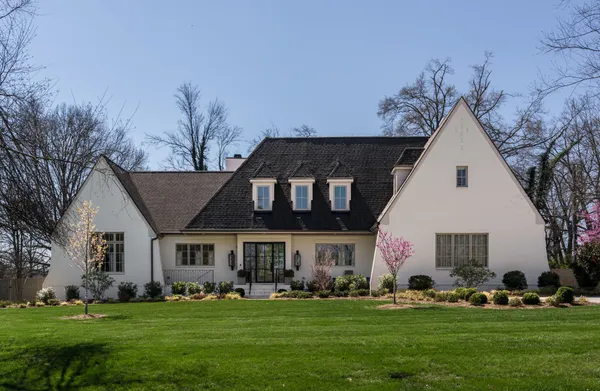 a front view of a house with a garden