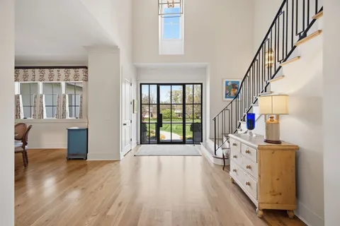 a bathroom with a granite countertop sink and mirror with bathtub