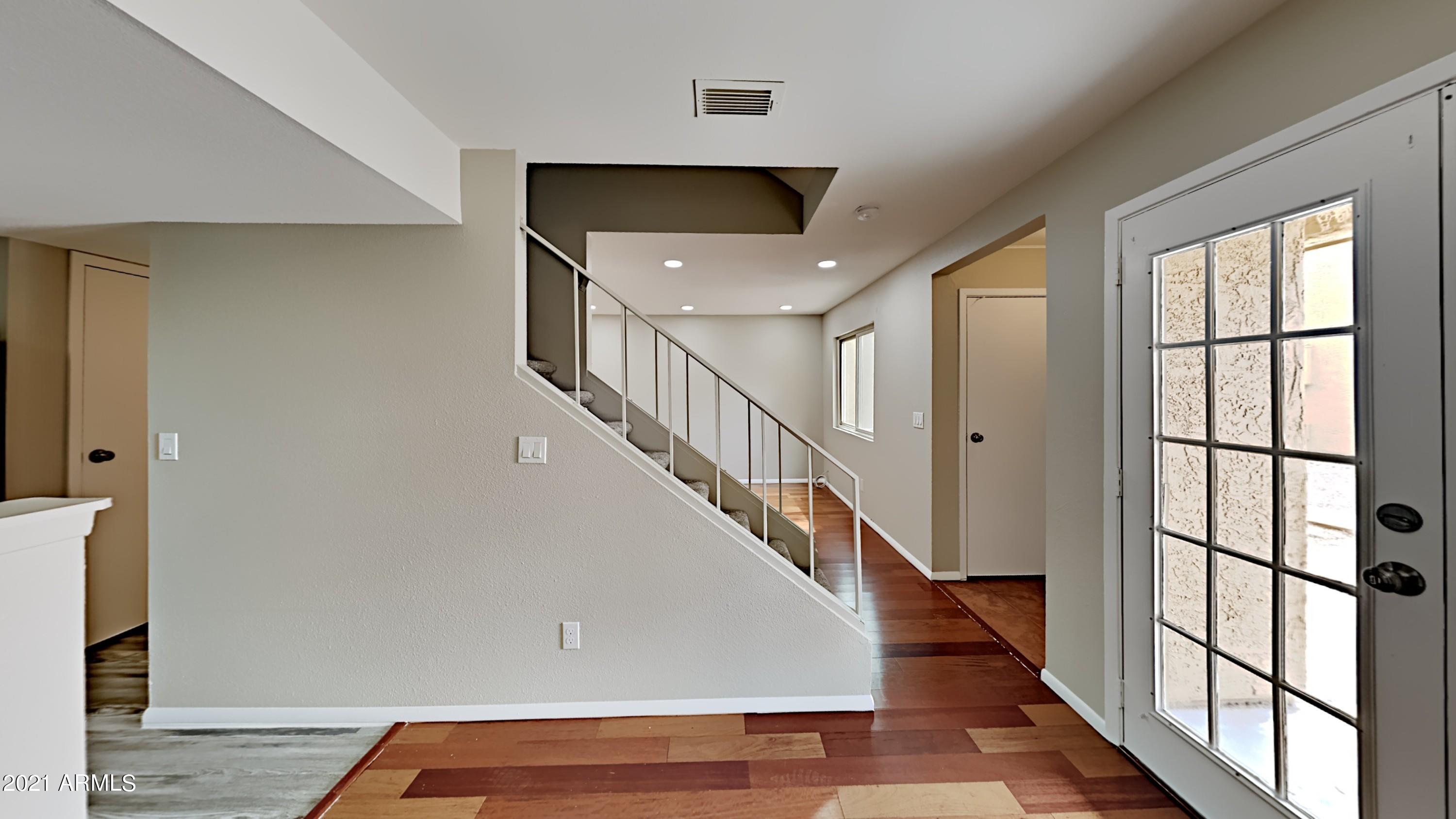 3511 East Baseline Road, Unit 1013 Phoenix, AZ 85042 - Photo 1 of 13 a view of entryway and hall with wooden floor