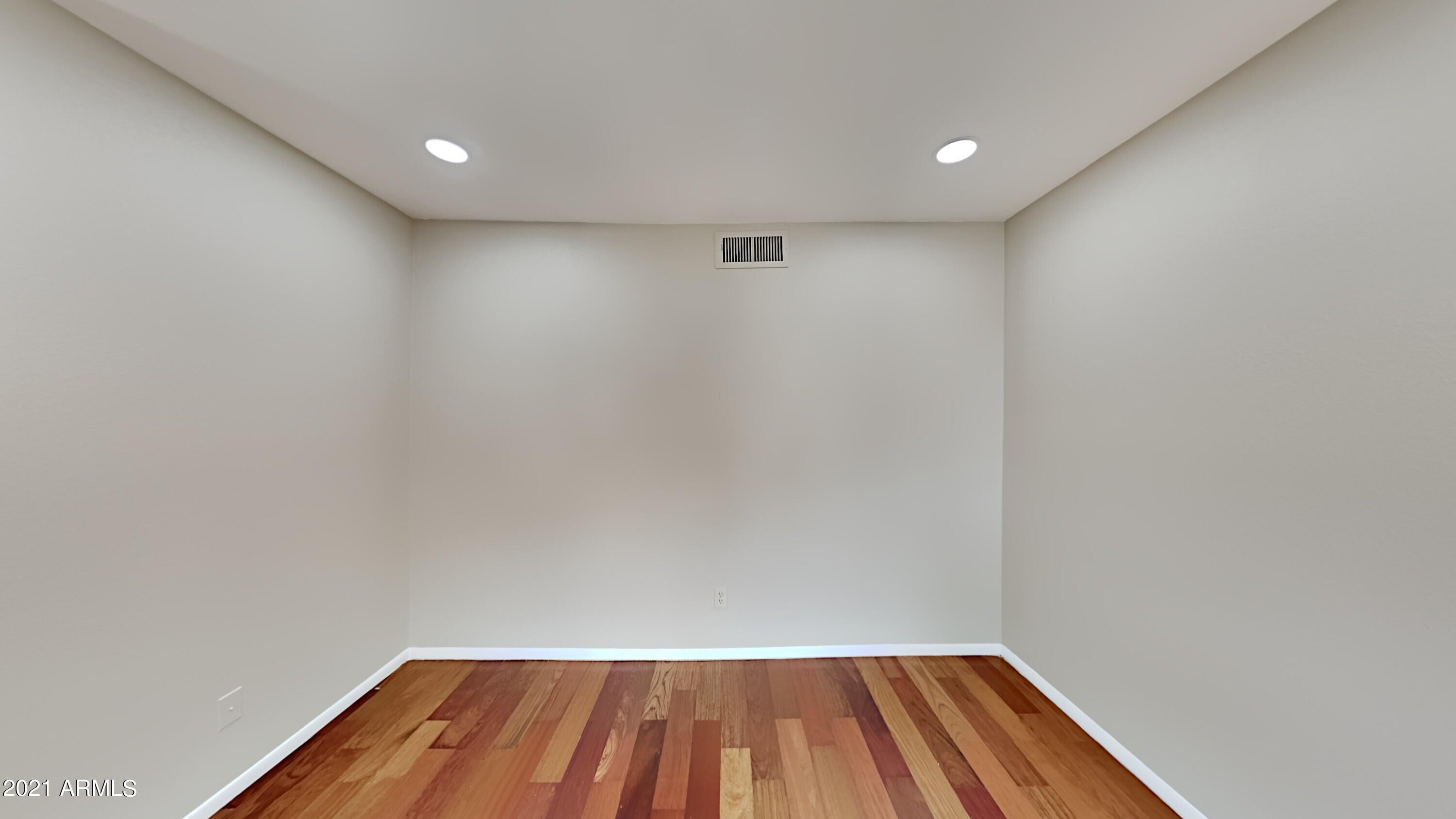 3511 East Baseline Road, Unit 1013 Phoenix, AZ 85042 - Photo 2 of 13 a view of room with wooden floor and fan